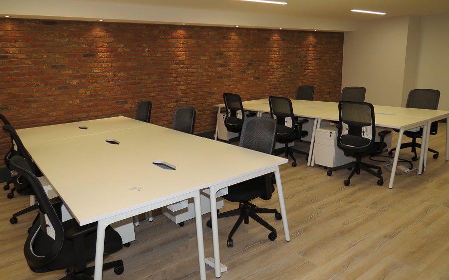 Why Is Office Furniture So Important? | Fusion Office Design White desks in bench style in a basement fit-out