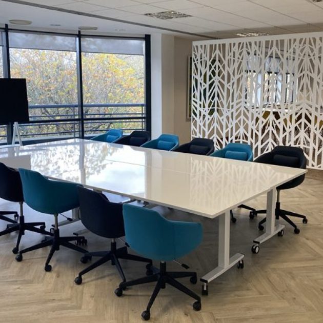 Tilt-top meeting tables with whiteboard tops for collaborative working in an open-plan office