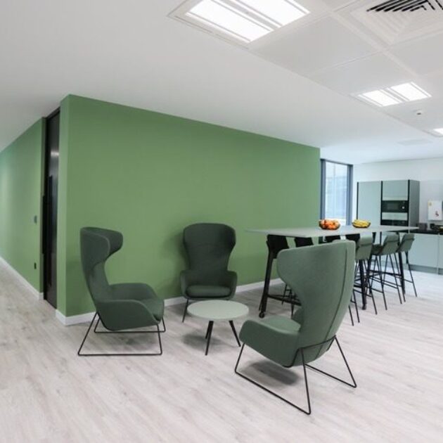 Teal feature wall with matching furniture in London office