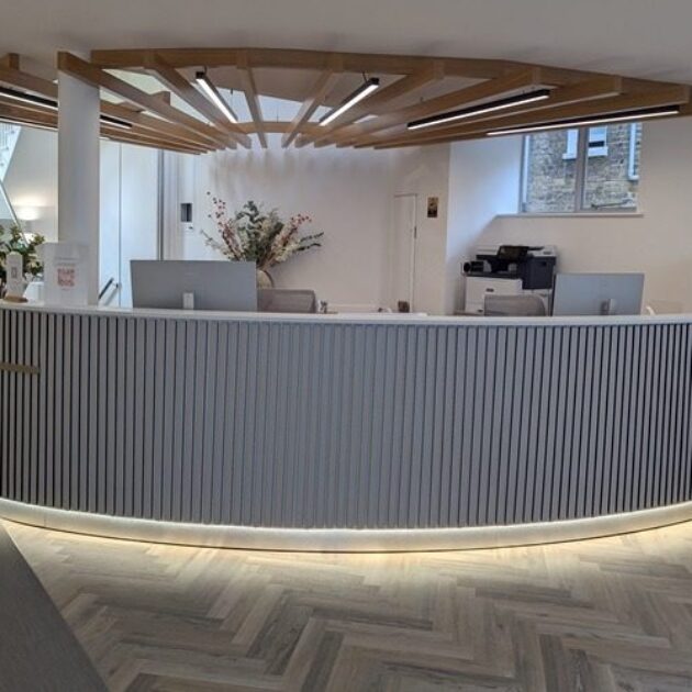Curved reception desk with fluted panelling in London office